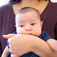 A parent holding the baby